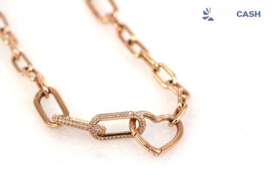 Gold heart pendant necklace in a white gift box on a black insert