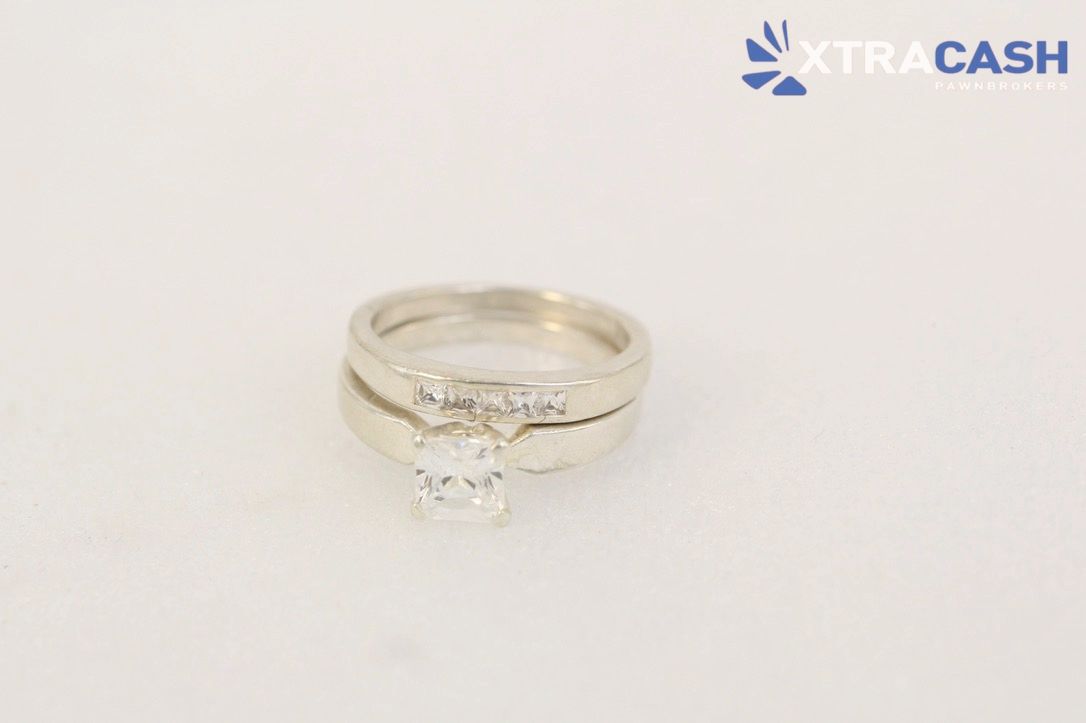 Silver ring with a large clear gemstone on a white background