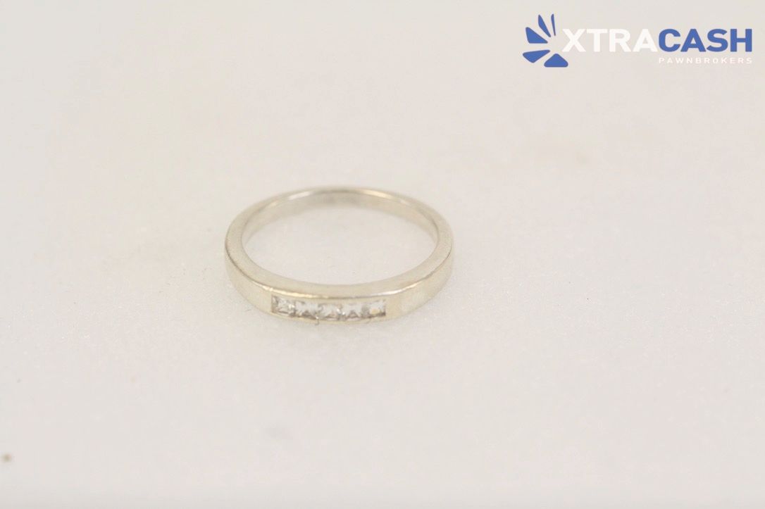 Silver ring with a large clear gemstone on a white background