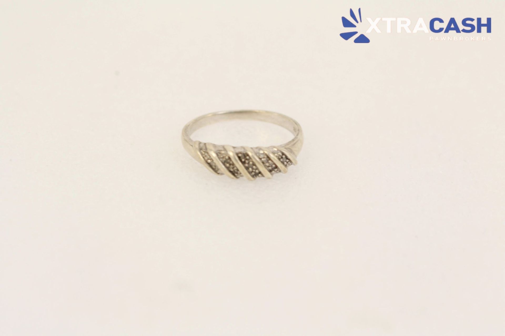 Silver ring with diagonal gold accents on a white background