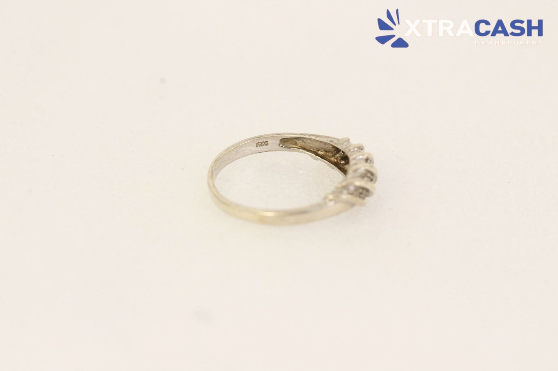 Silver ring with diagonal gold accents on a white background