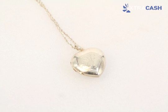Silver heart pendant necklace on a light background