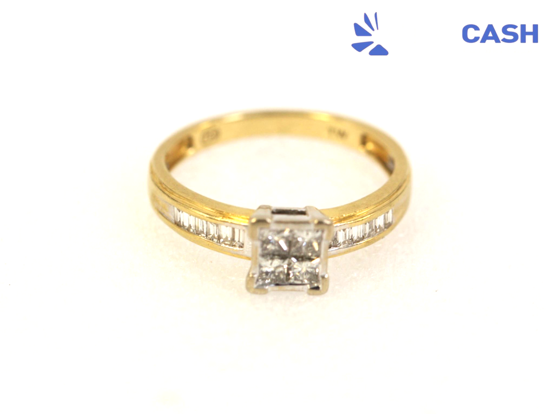 Gold ring with square diamond setting and small side stones on a white background
