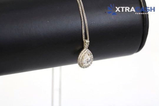 Silver necklace with a circular pendant on a white background.