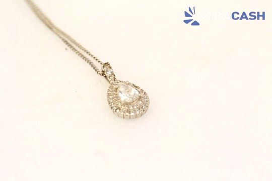 Silver necklace with a circular pendant on a white background.