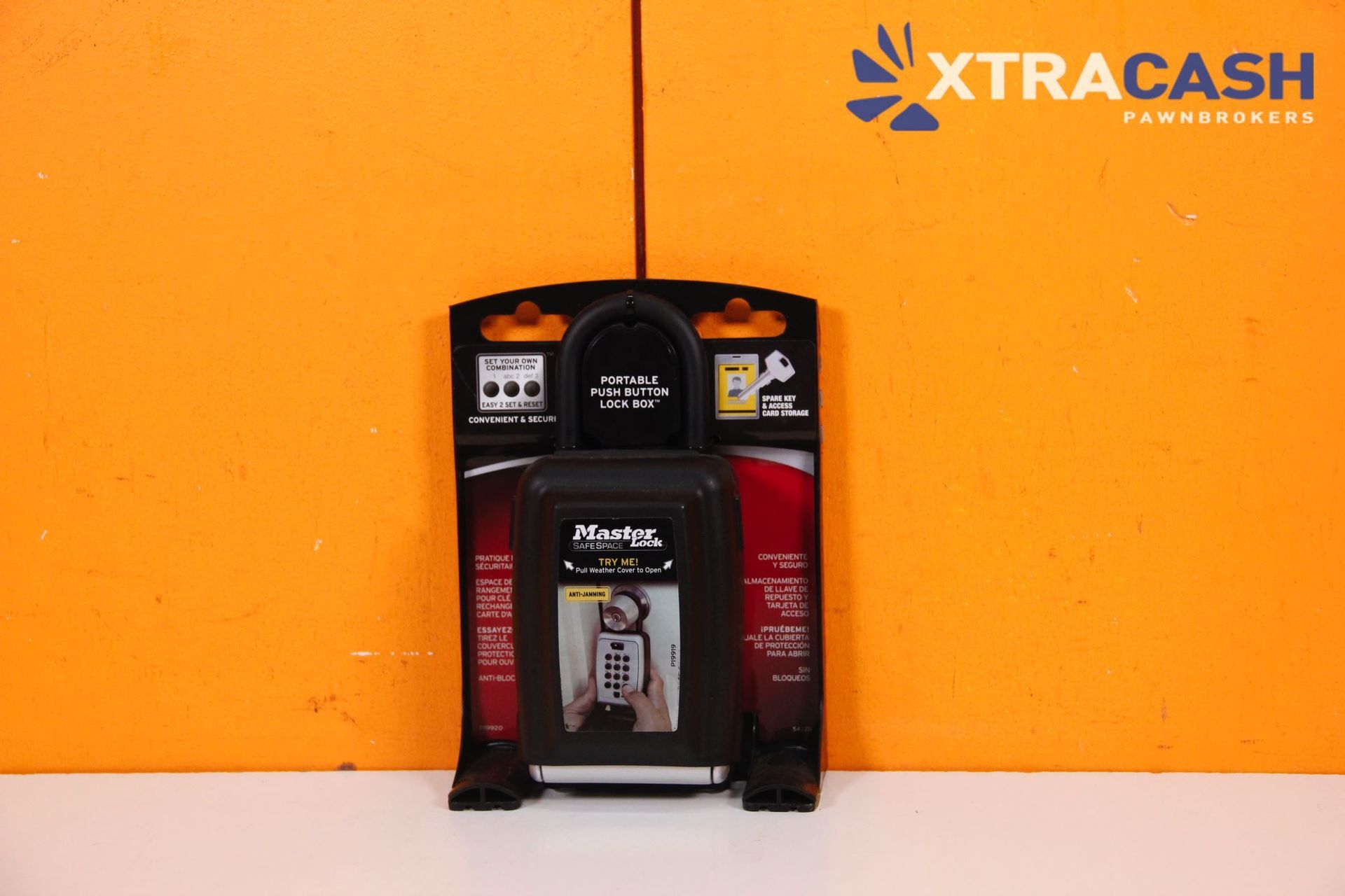 Xtracash-branded ATM kiosk against a bright orange wall