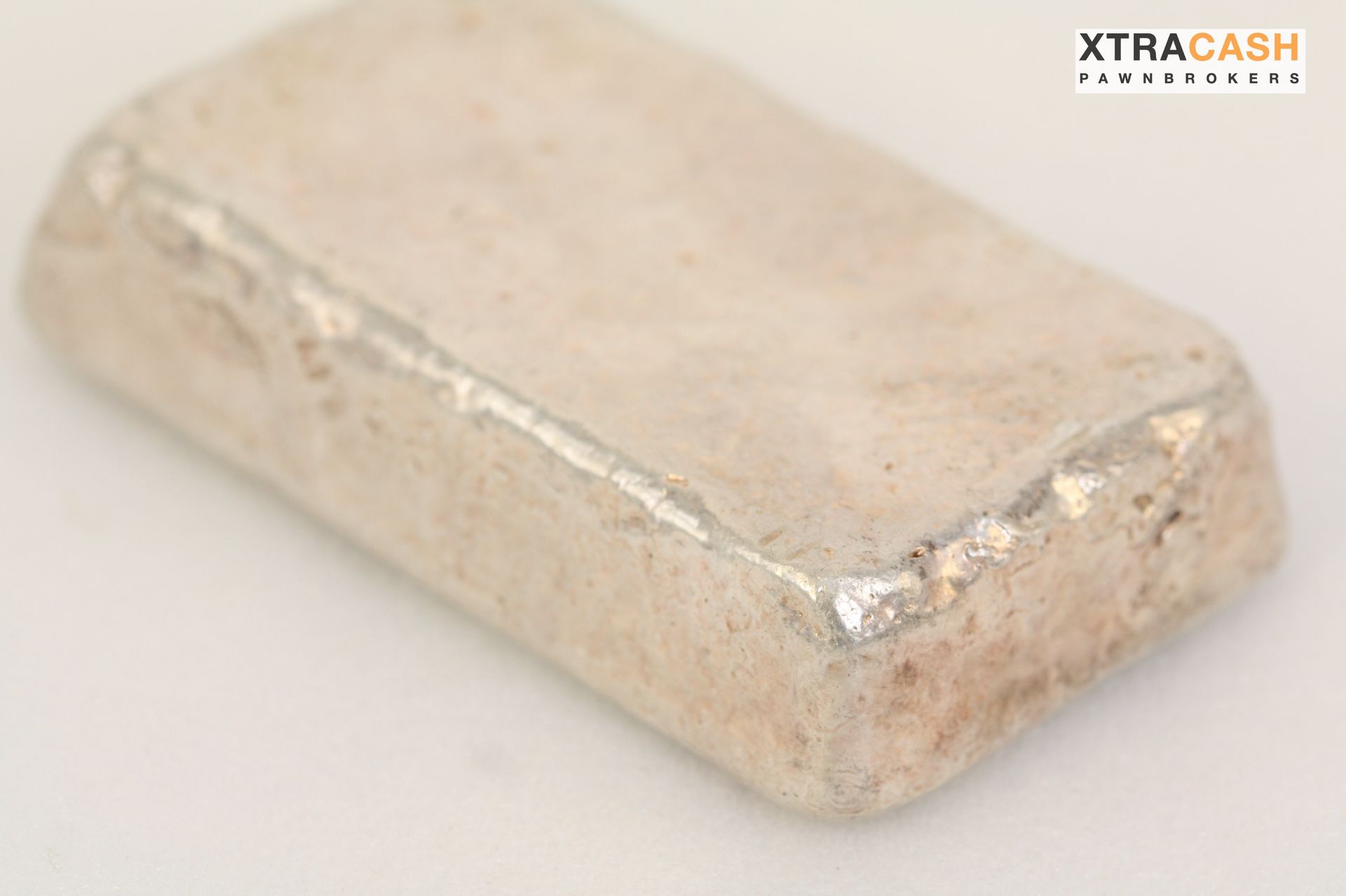 Rectangular silver bullion bar on a white background