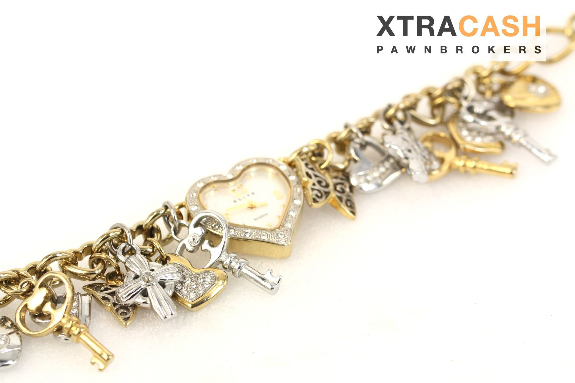 Gold and silver charm bracelet with a heart centerpiece on a white background