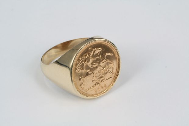 Gold signet ring with an engraved face on the round bezel