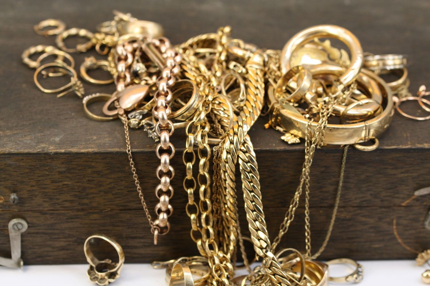 Pile of gold jewelry on a wooden surface