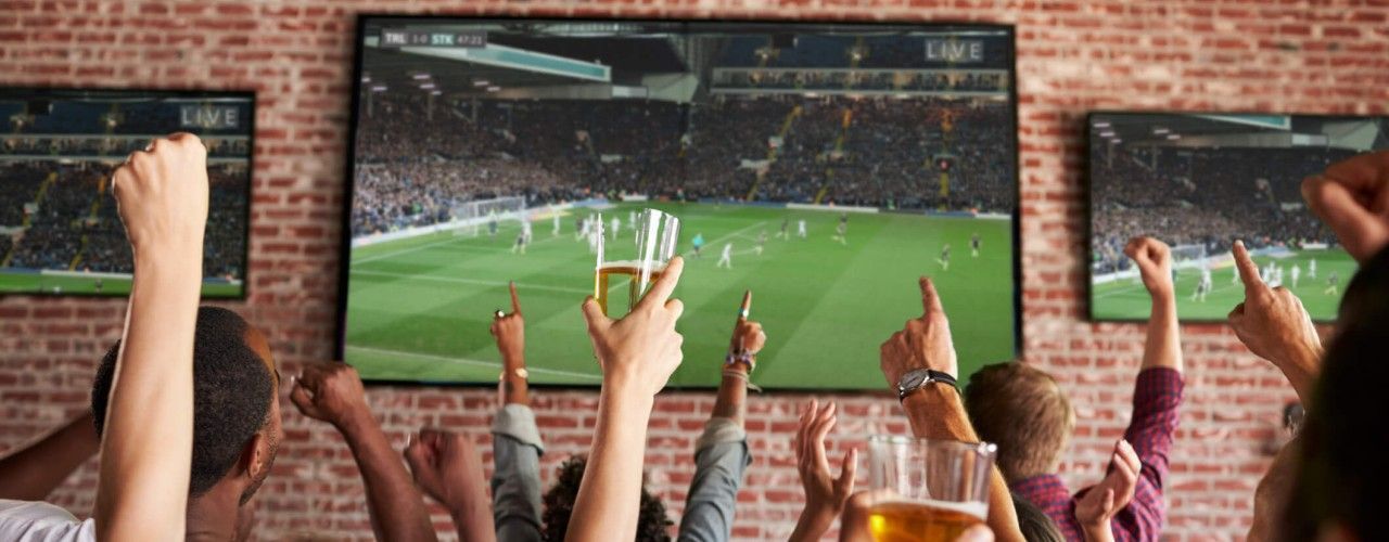 multi-screen TVs on wall in commercial venue for live sport