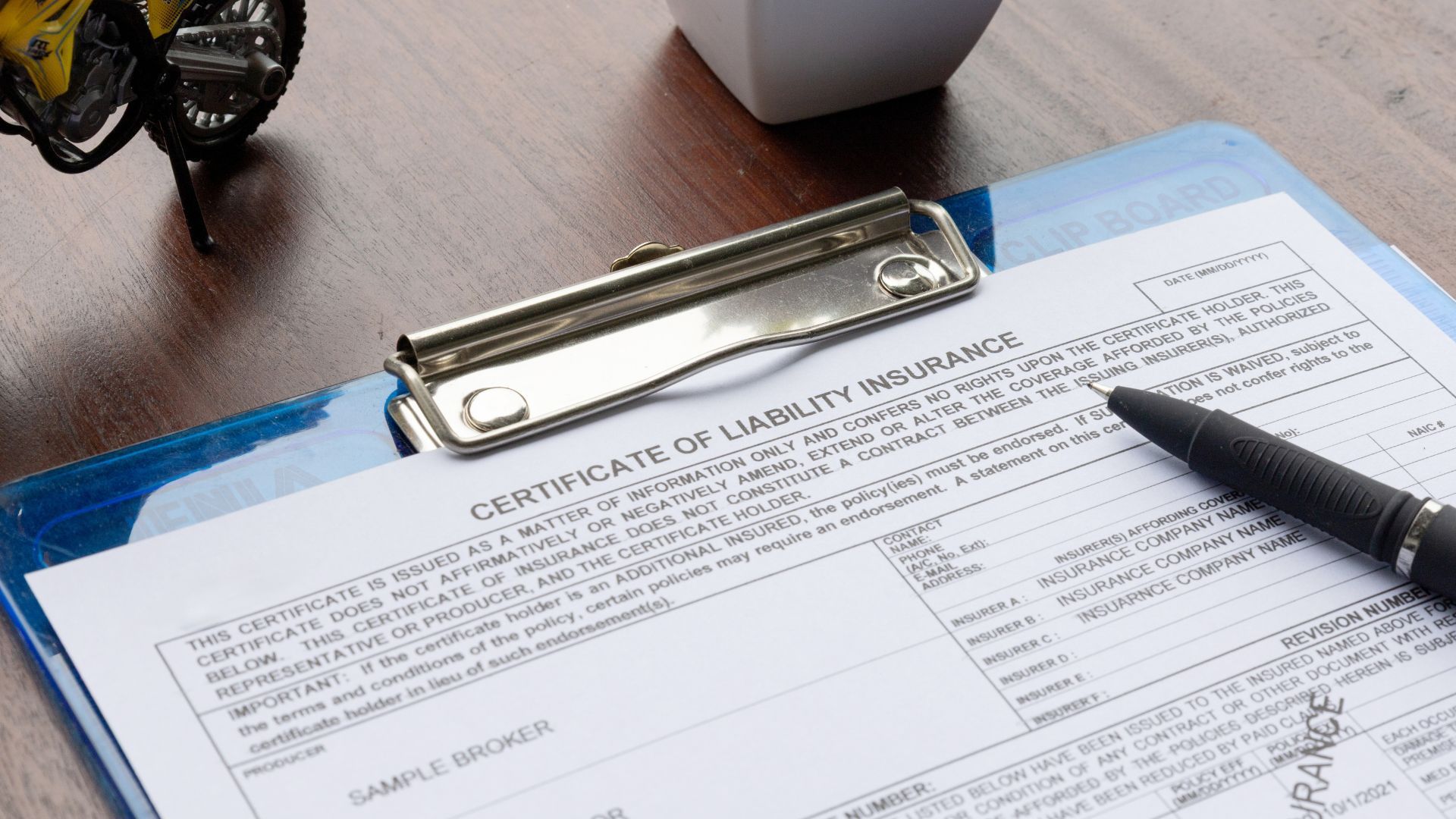 A magnifying glass is held over a document with the large blue text