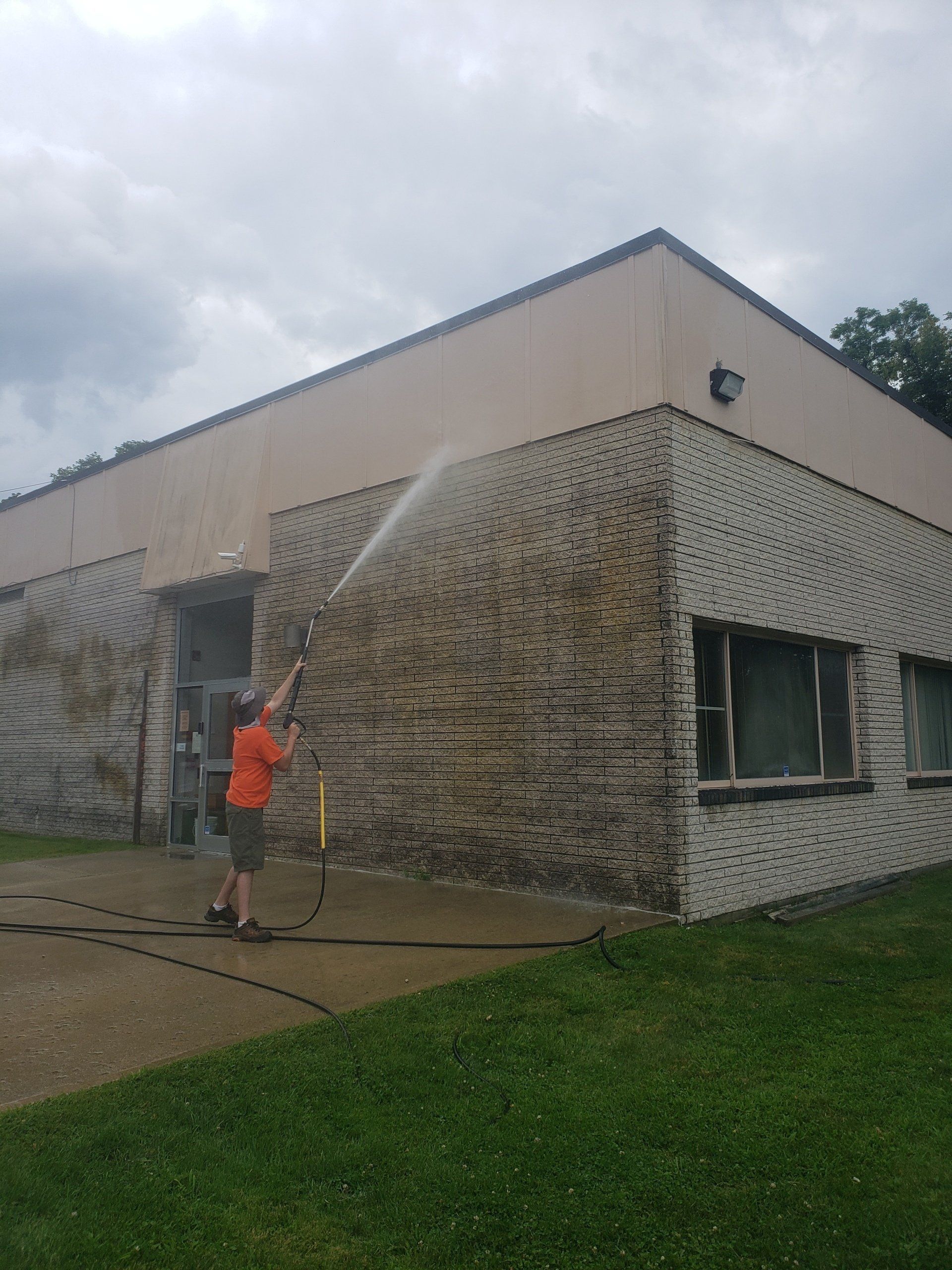Professional Worker Cleaning Dirty Wall