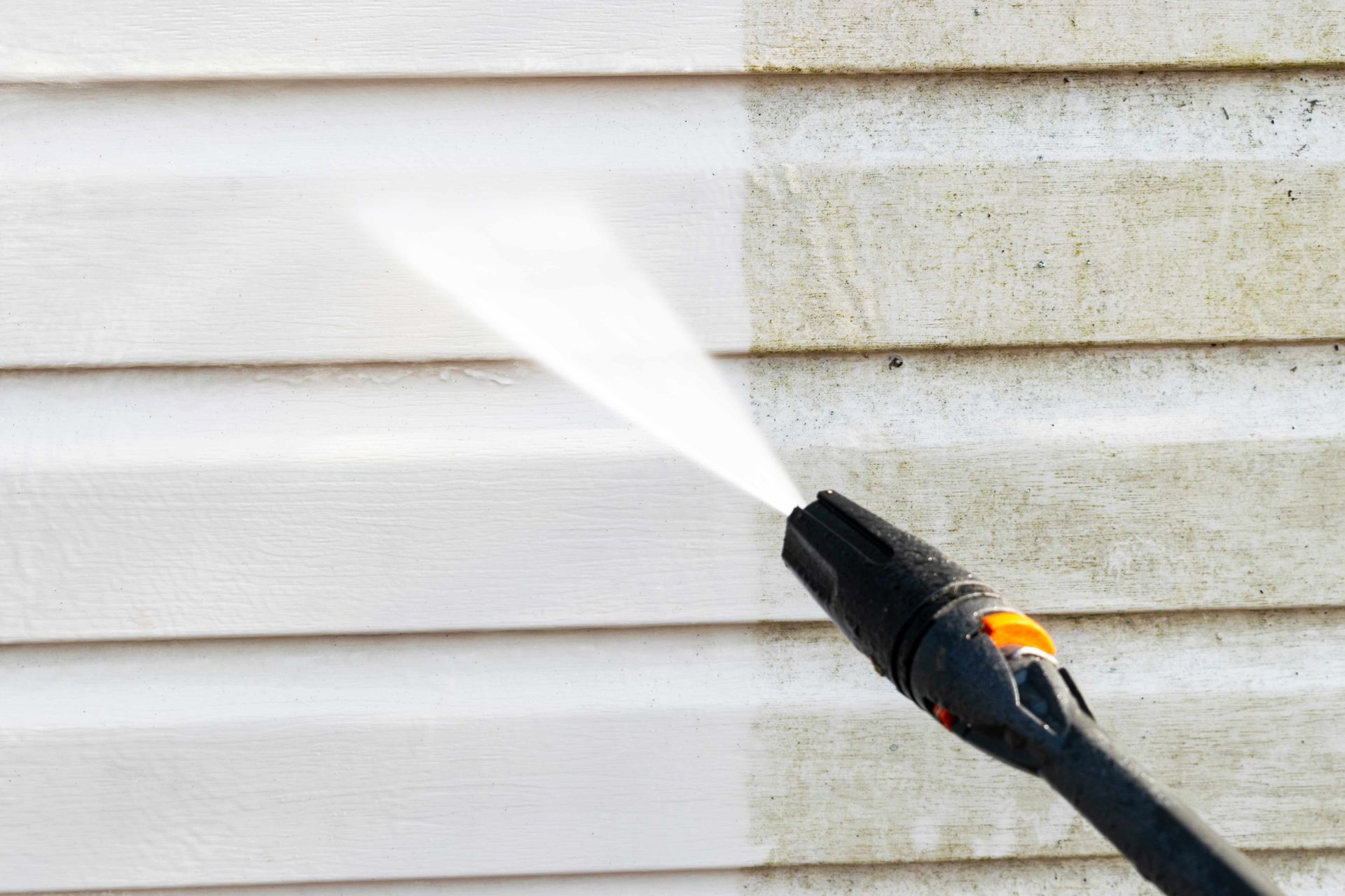 Exterior pressure washing on vinyl siding showing removal of dirt mold and grime with strong power. Exterior pressure washing on vinyl siding showing removal of dirt mold and grime with strong power.