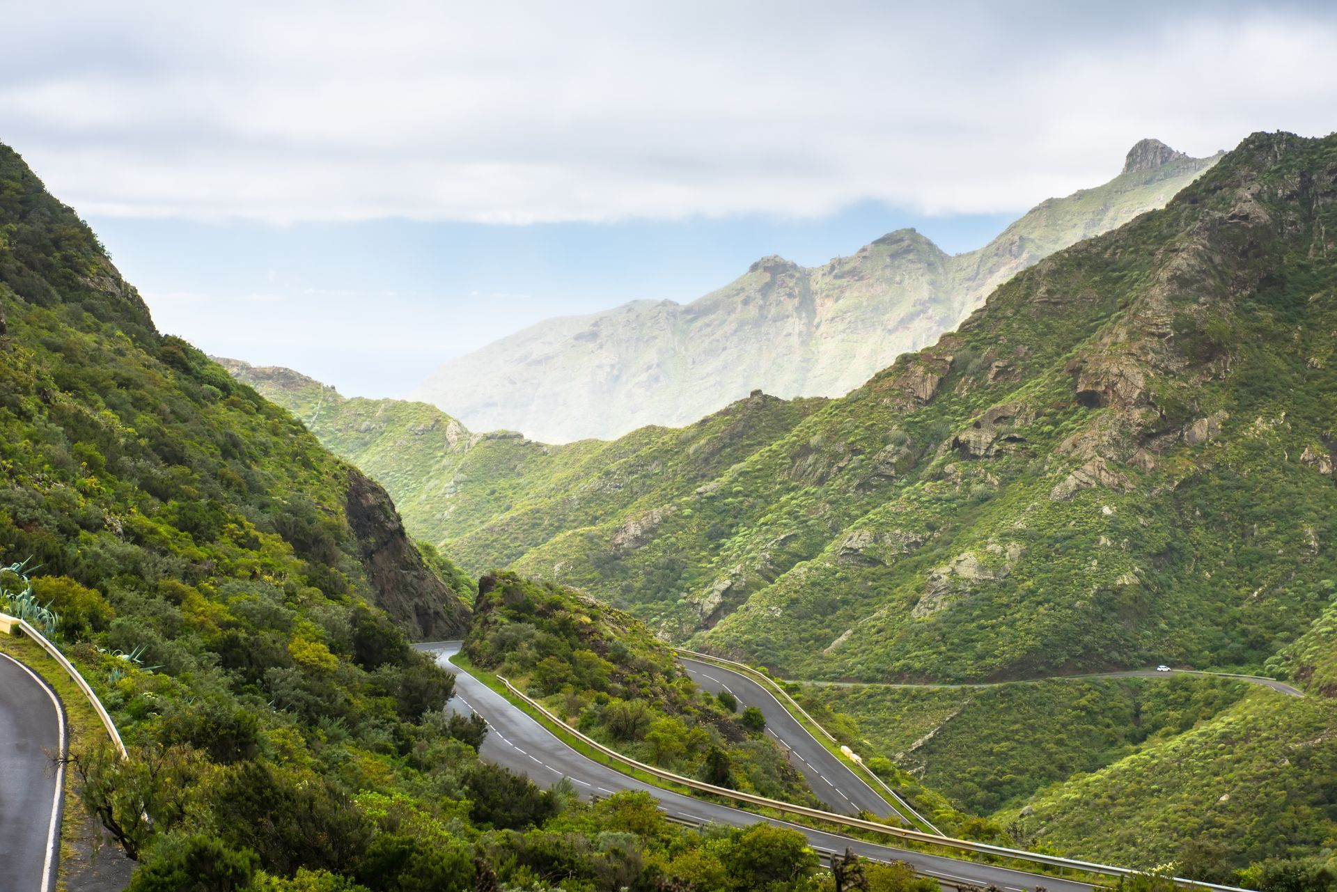 A road going through a valley surrounded by mountains.