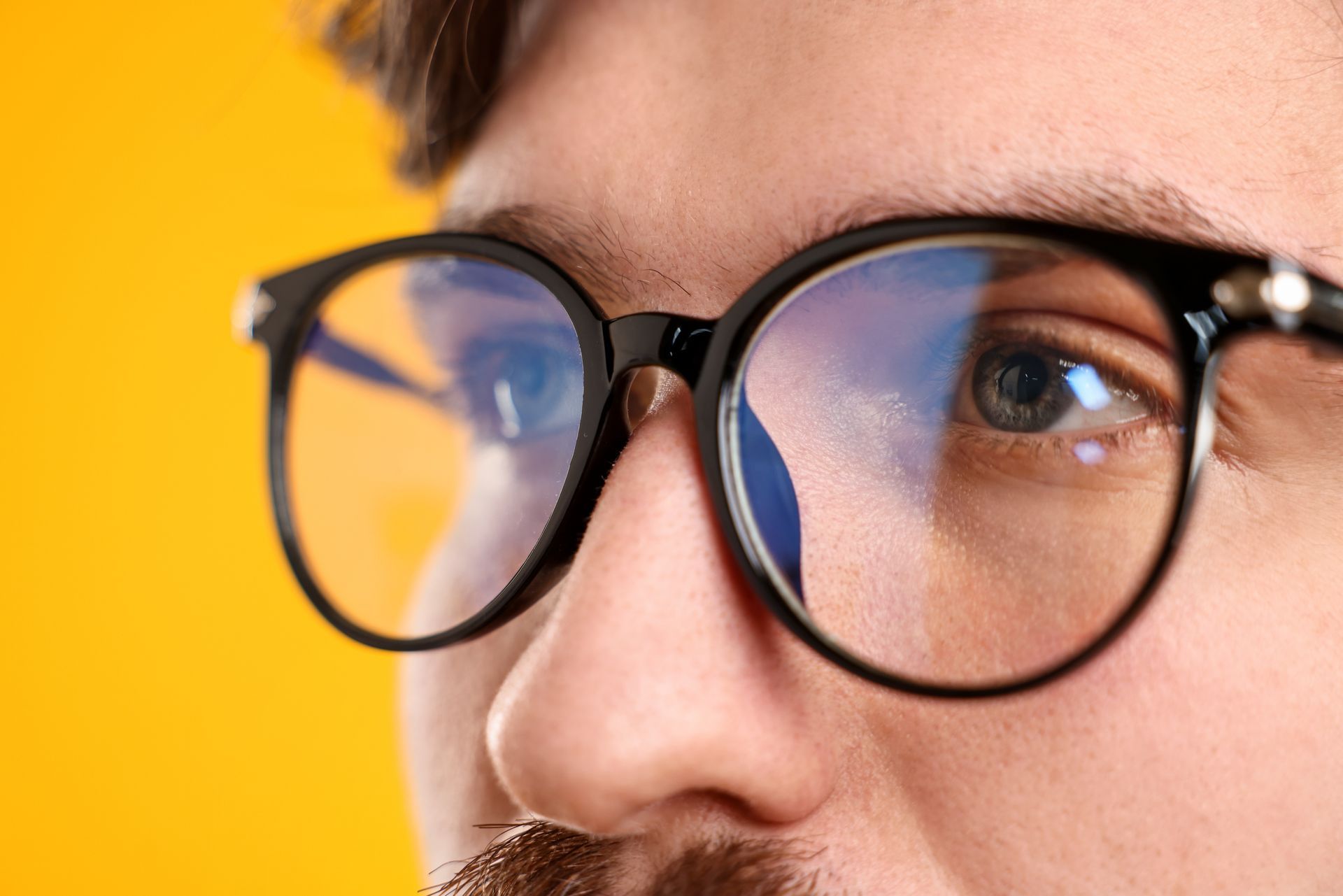 Close-up of a man wearing stylish black frames with high-quality vision shaping lenses. Close-up of a man wearing stylish black frames with high-quality vision shaping lenses.
