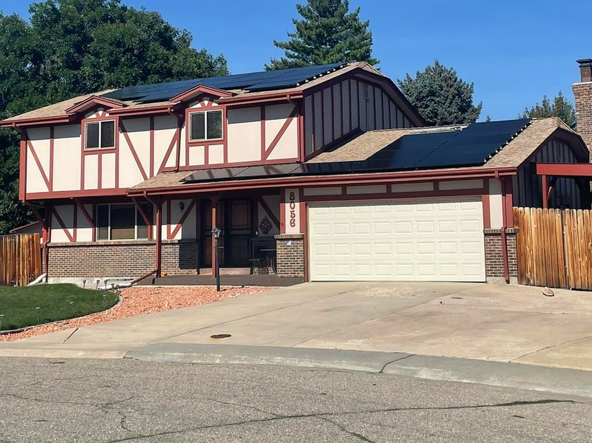 A large house with solar panels on the roof