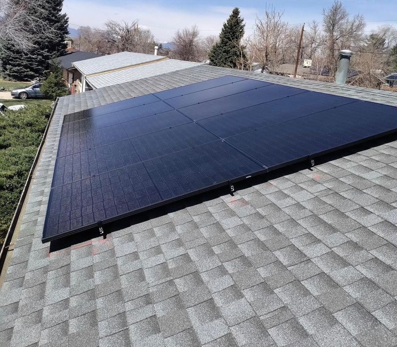 A large solar panel is sitting on top of a roof.