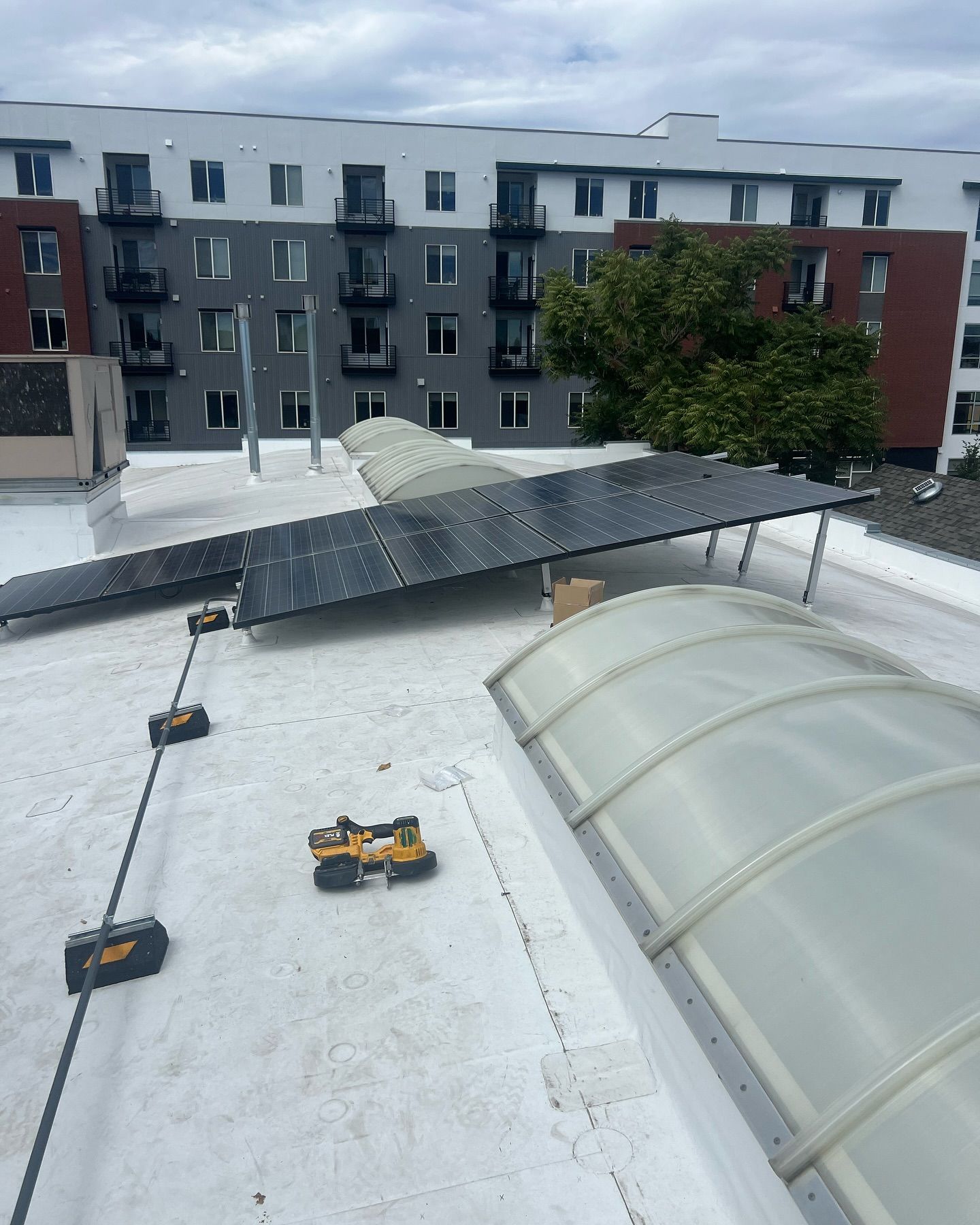 A roof with solar panels and a dome on it