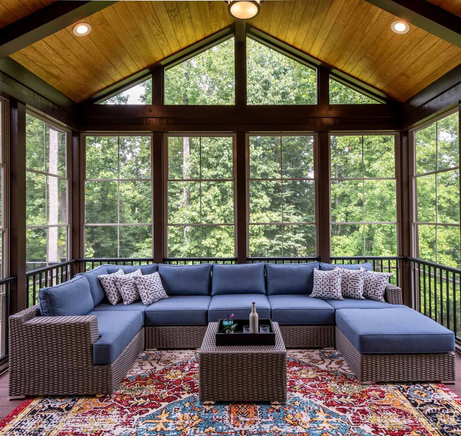 Screened Porch with a Blue Sofa and Coffee Table
