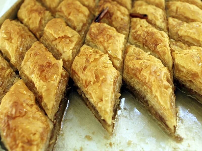 A close up of a tray of baklava slices on a table.