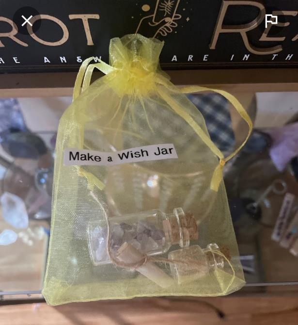 A yellow bag that says make a wish jar on it