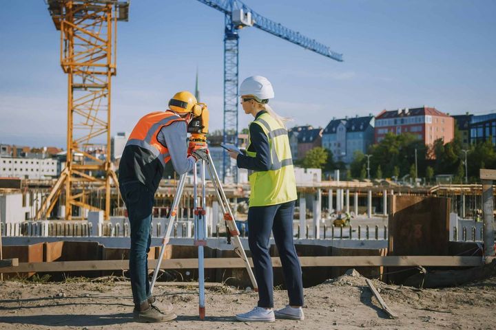 A man and a woman are working on a construction site.