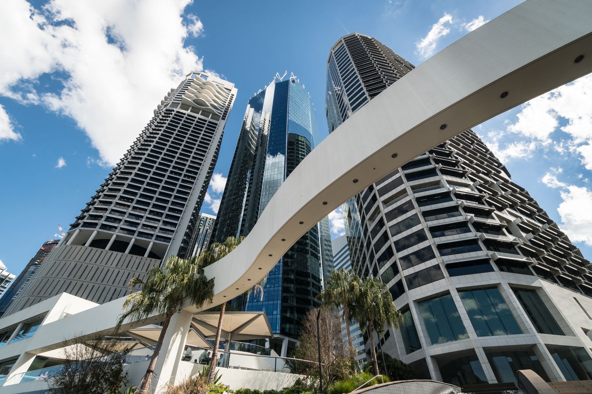 A bridge between two tall buildings in a city