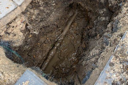 Hole dug down to water pipe