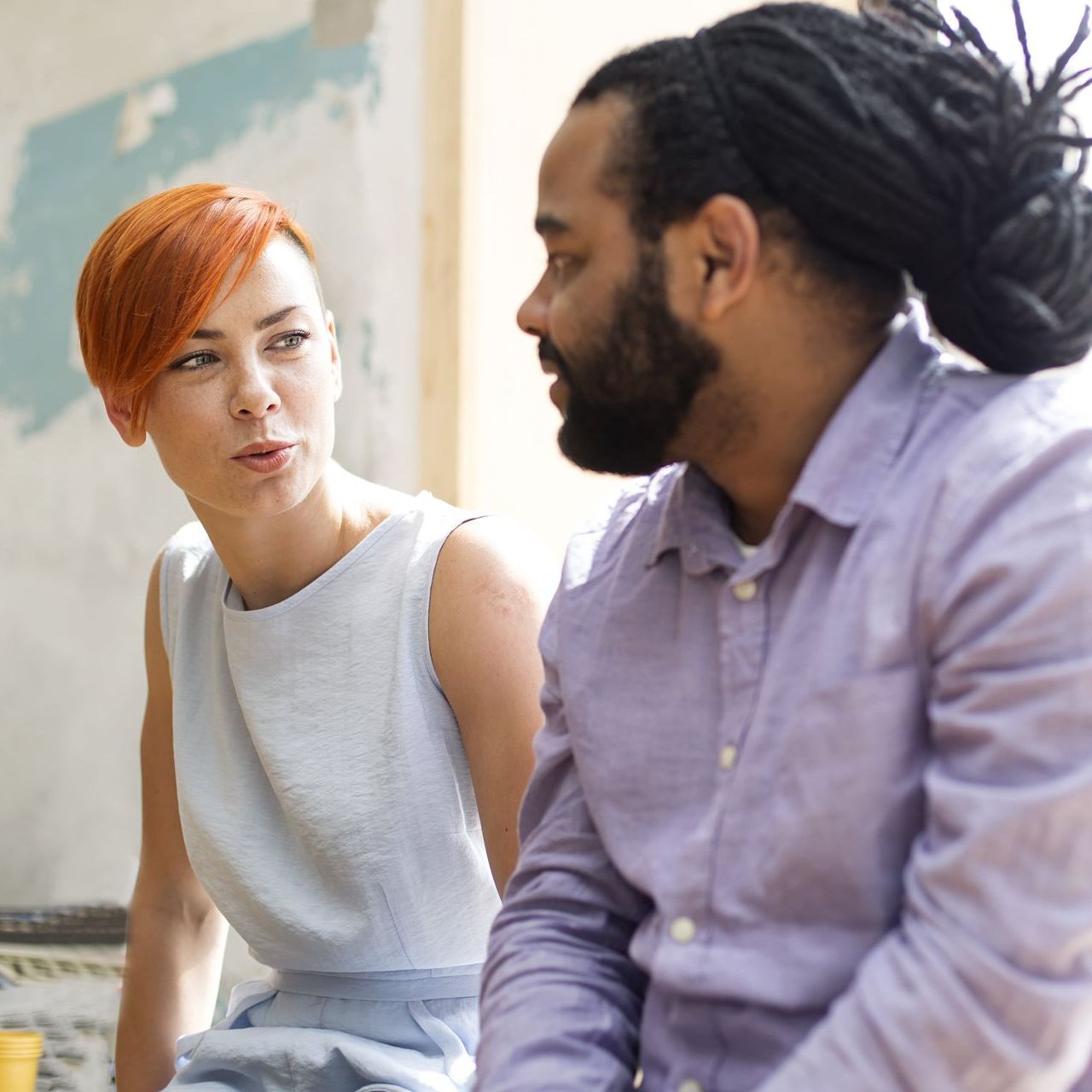 A man and a woman are sitting next to each other and talking