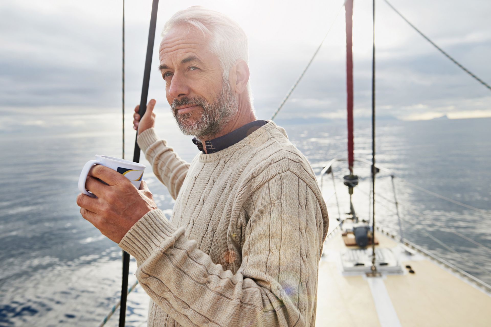Man on His Sailboat Drinking a Cup of Coffee — Bokeelia, FL — TowBoatUS Charlotte Harbor Man on His Sailboat Drinking a Cup of Coffee — Bokeelia, FL — TowBoatUS Charlotte Harbor