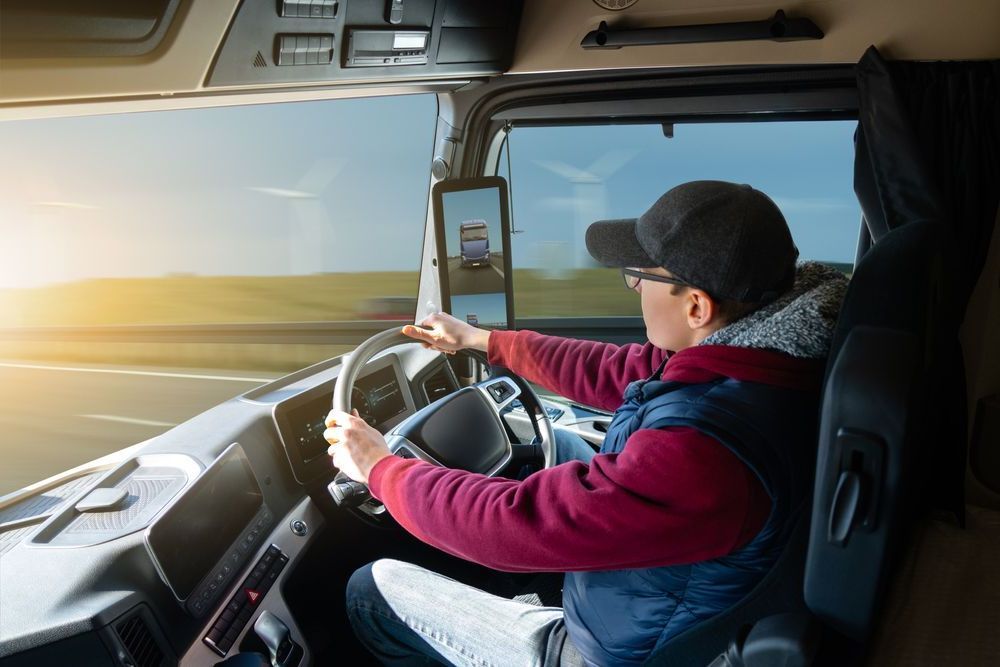 Man Driving Truck While Looking At GPS — Cairns Traffic Lawyers In Cairns, QLD