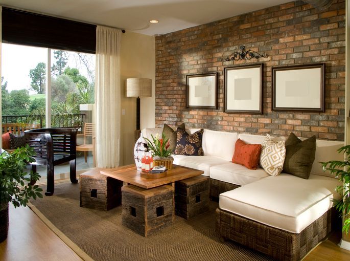 A living room with a brick wall and a couch