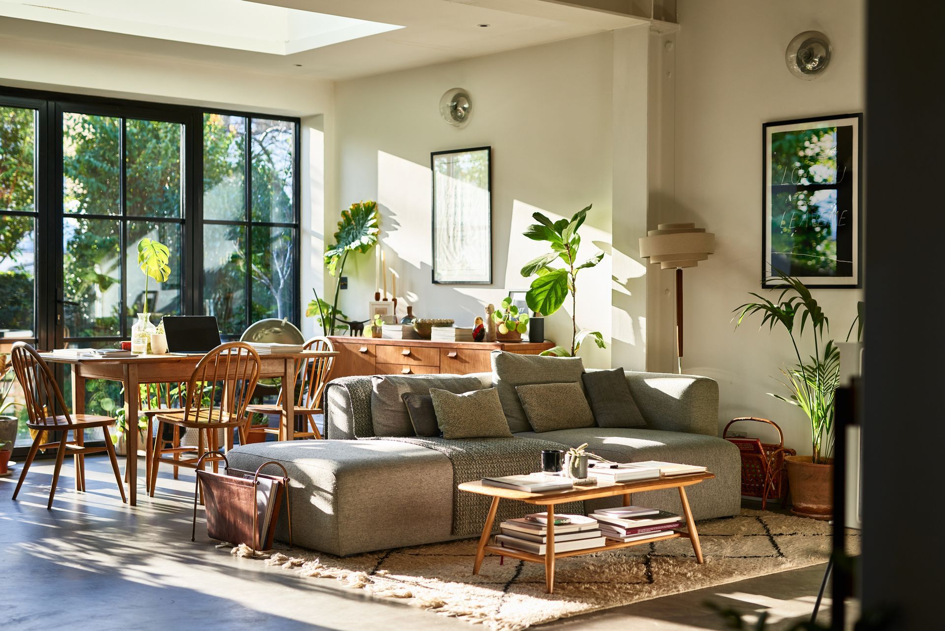 A living room with a couch , table and chairs.