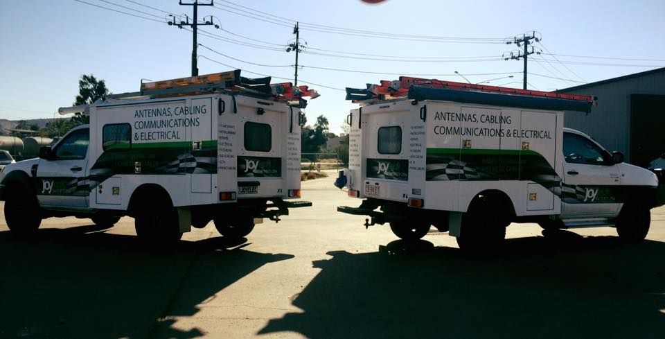 Two Trucks Are Parked Next to Each Other on the Side of the Road — Joytech In Adelaide, SA