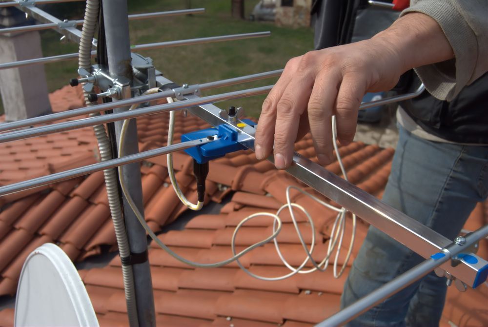 A Man is Working on an Antenna on the Roof of a House — Joytech In Ciccone, NT