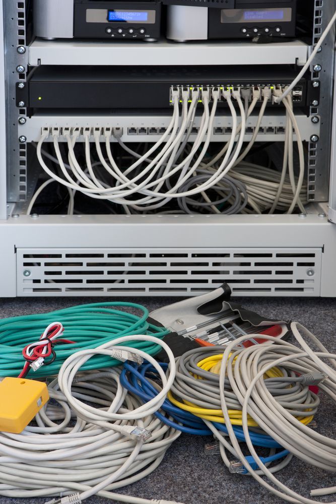 A Bunch of Wires Are Laying on the Floor in Front of a Server — Joytech In Adelaide, SA