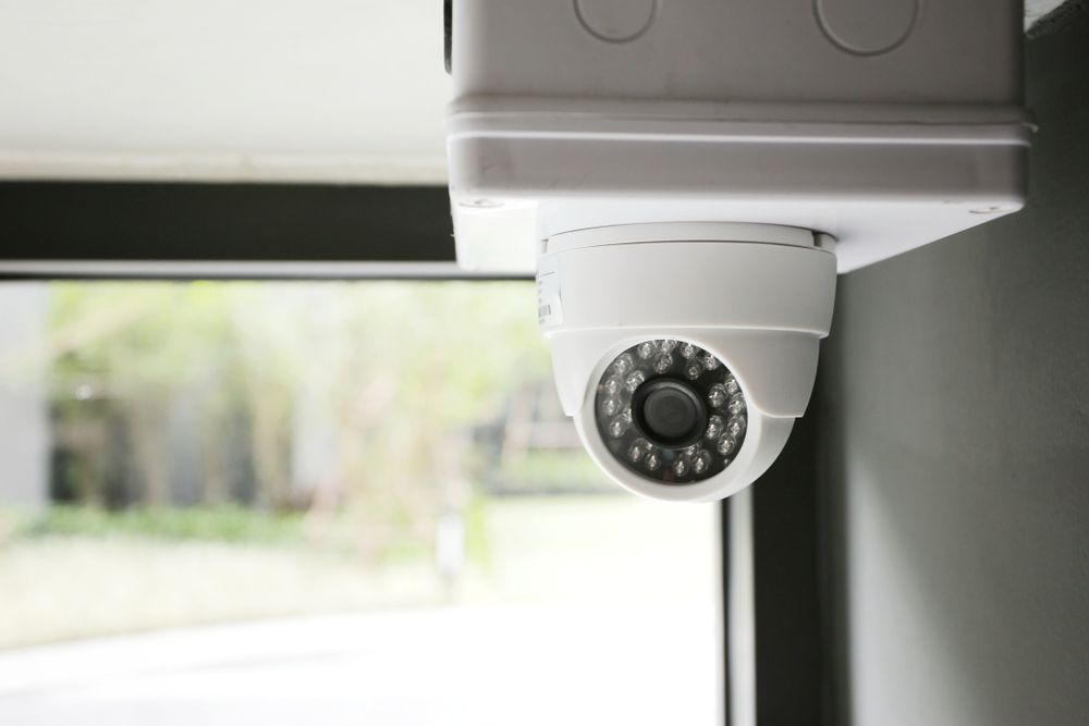 A Security Camera Is Hanging From The Ceiling Next To A Window — Joytech In Ciccone, NT
