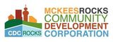 McKees Rocks Community Development Corporation logo with green, orange, and blue houses and text