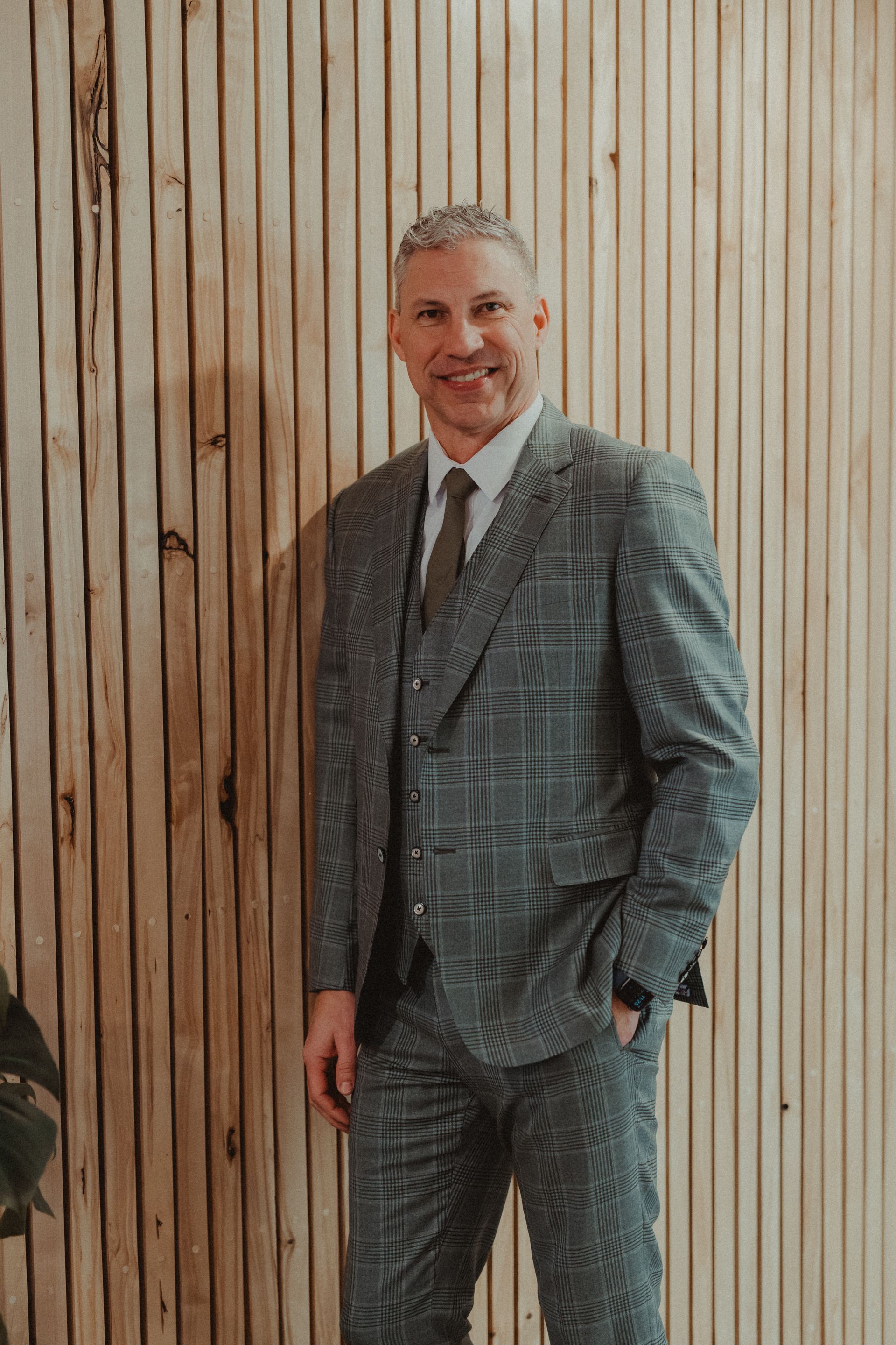 A man in a suit and tie is sitting in a chair.