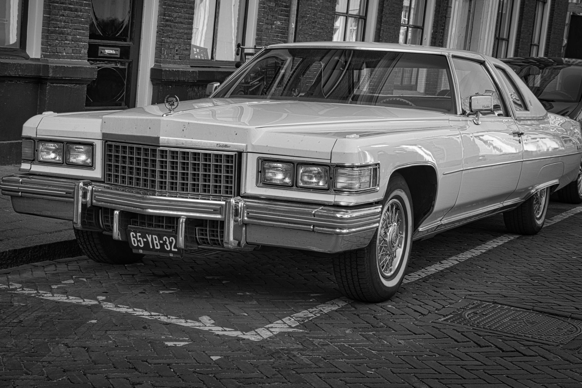 Classic Cadillac parked on a city street at night
