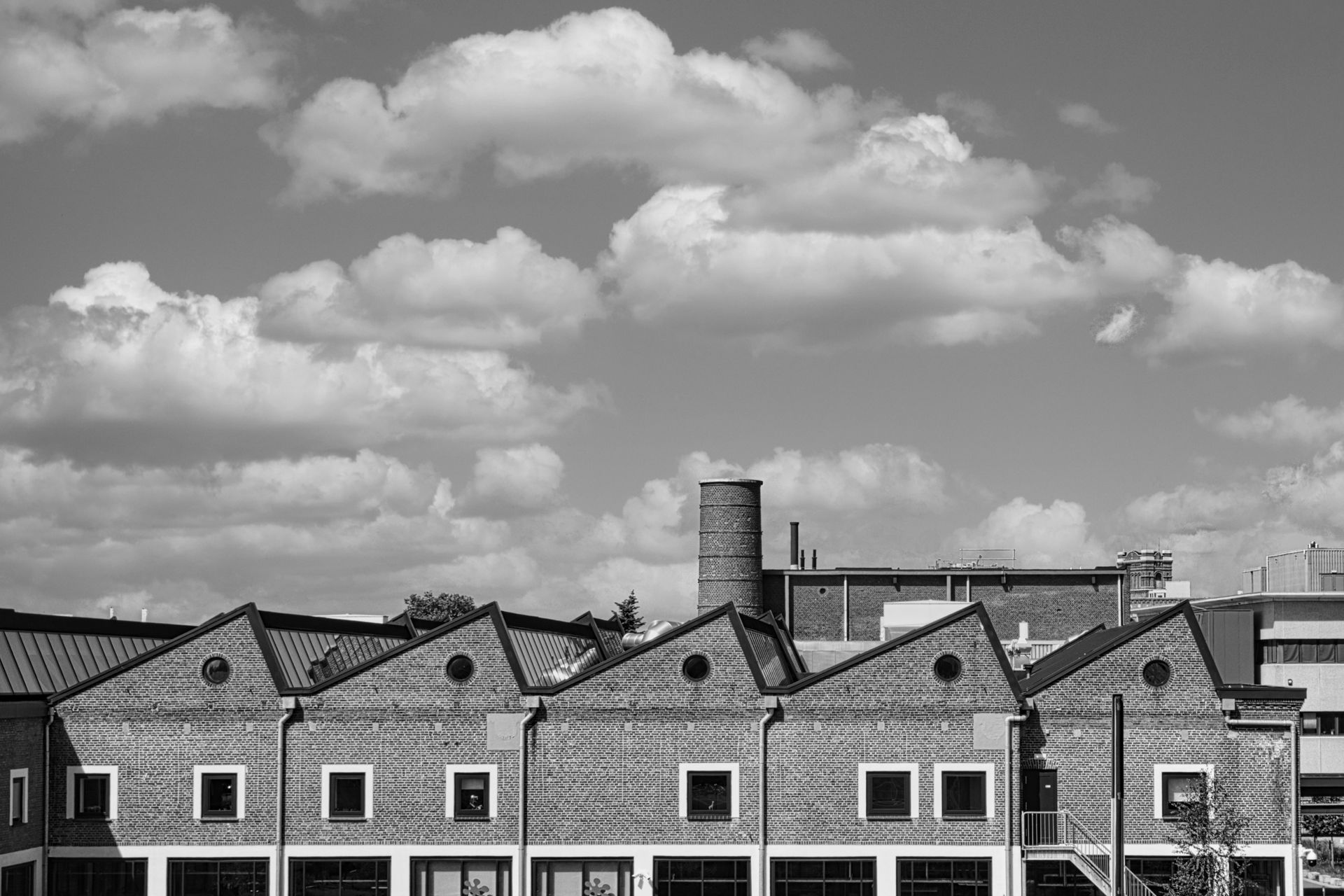 Rooftop of factory beneath a cloudy sky