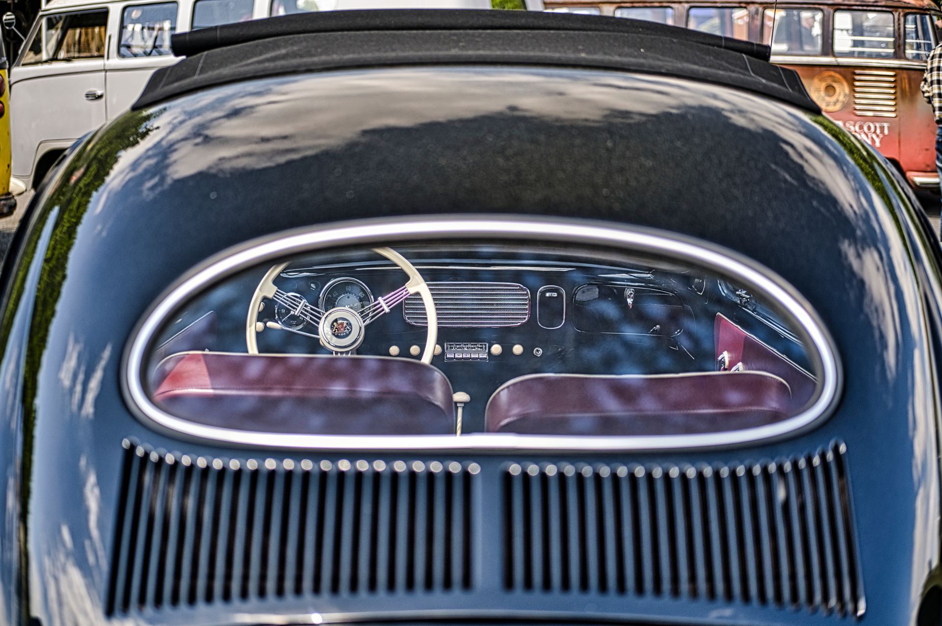 Rear view of a Volkswagen Beetle with a rounded rear window and visible interior seats