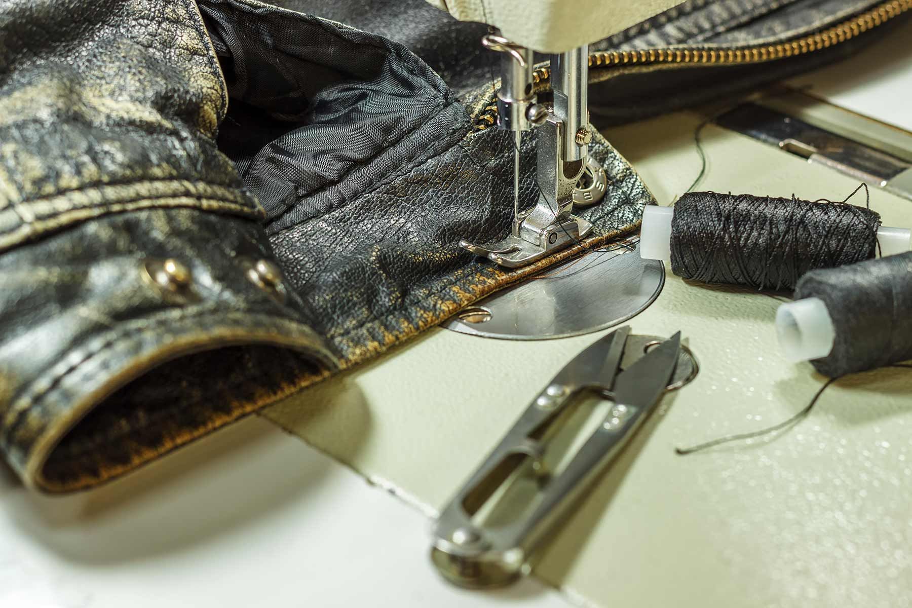 A Sewing Machine Is Working On A Piece Of Leather — The Sewing Machine Doctor In Forest Glen, QLD