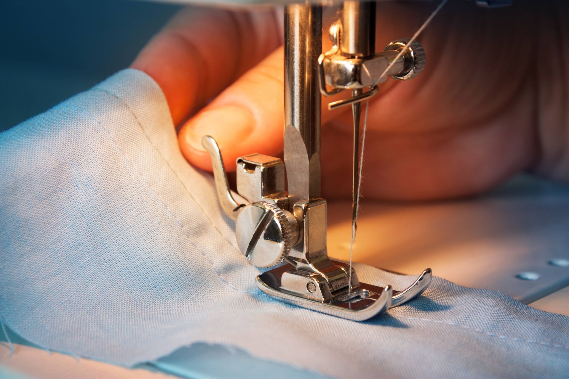 A Person Is Using A Sewing Machine To Sew A Piece Of Fabric — The Sewing Machine Doctor In Forest Glen, QLD