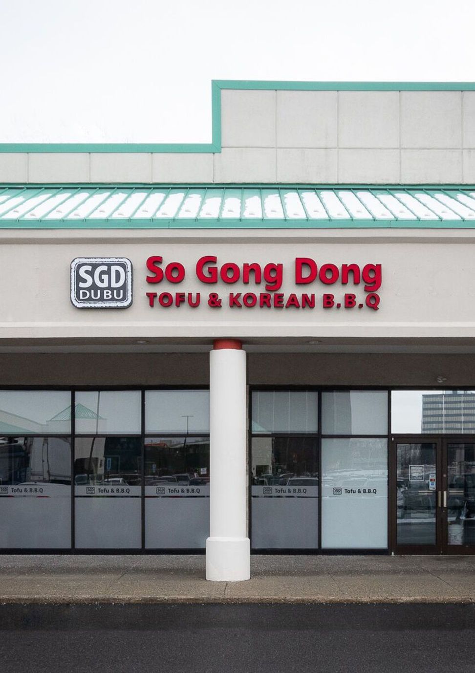 Storefront of So Gong Dong Tofu & Korean BBQ with teal roof, red sign, and white columns