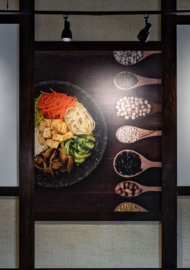Overhead view of a colorful plated meal with assorted ingredients and spoons of seasonings on the side