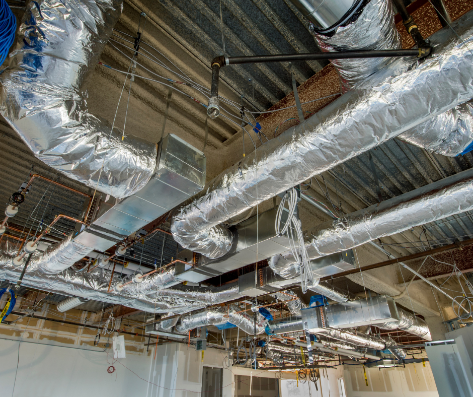 A room with a lot of pipes hanging from the ceiling.