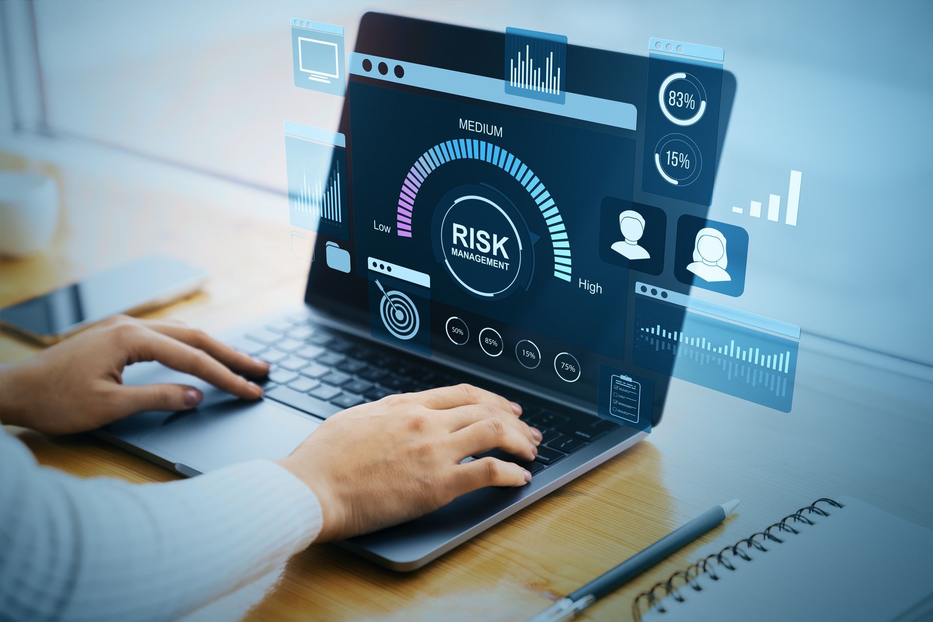 Hands typing on a laptop with a cybersecurity risk dashboard and digital icons overlaid