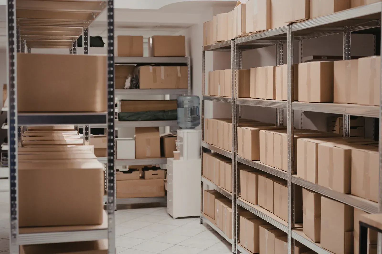 Shelves filled with stacked cardboard boxes in a storage room interior